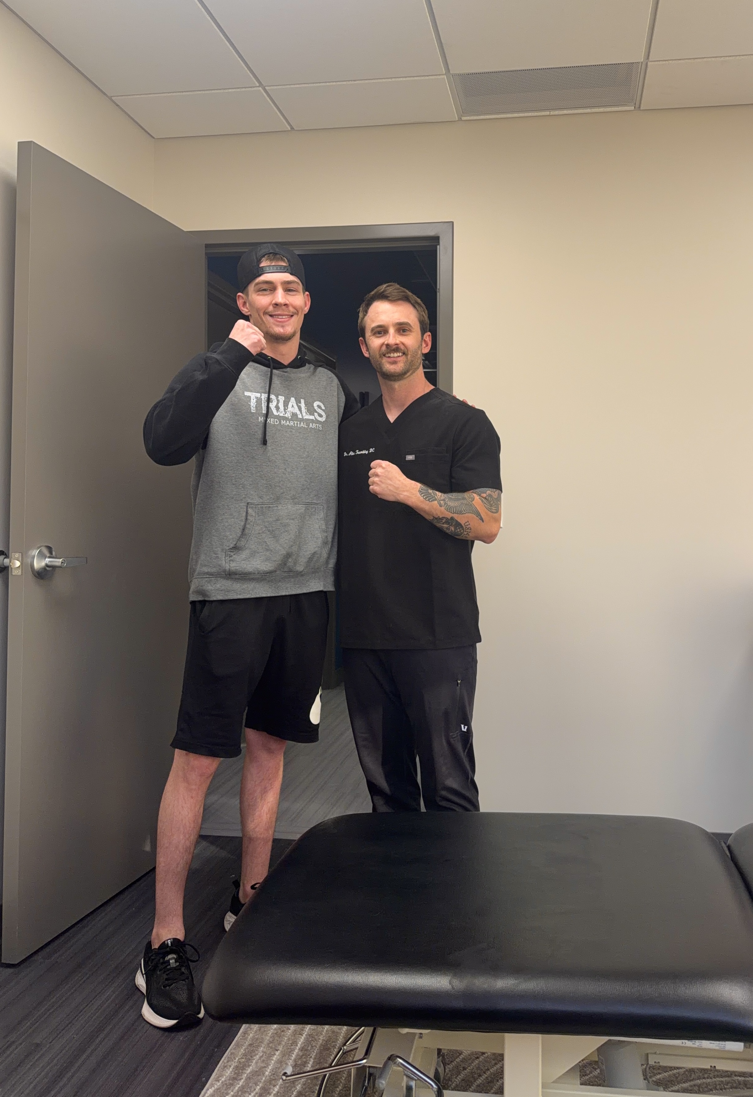 Dr. Alec Tramblay with a grappling athlete after sports injury rehab at Tier 1 Performance and Rehab in Fort Collins