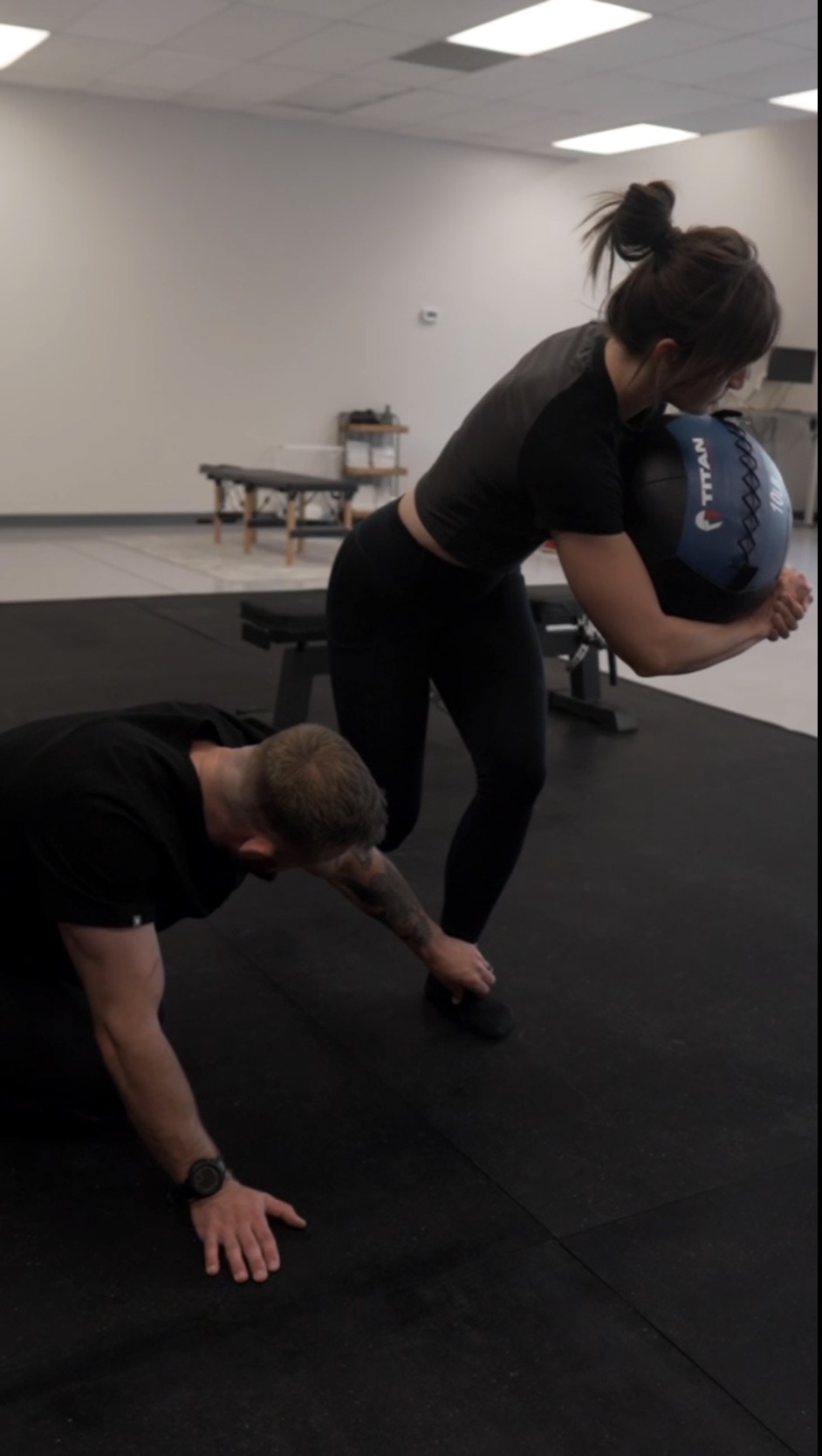 Dr. Alec Tramblay coaching a patient through loaded mobility work at Tier 1 Performance & Rehab in Fort Collins